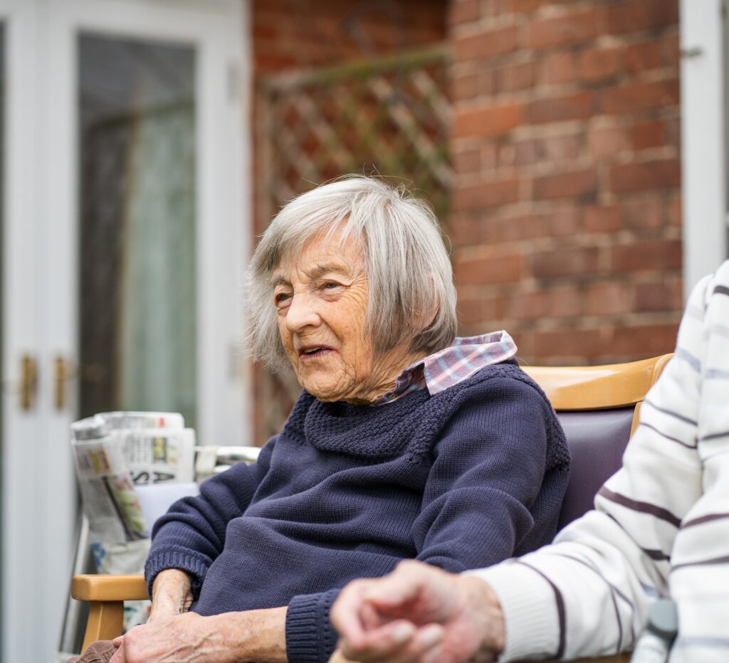 resident sat outside in chair