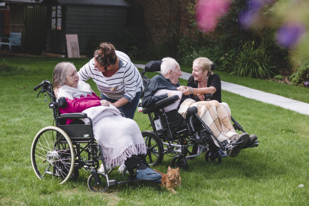 Sefton Hall team members with residents in the care home garden.