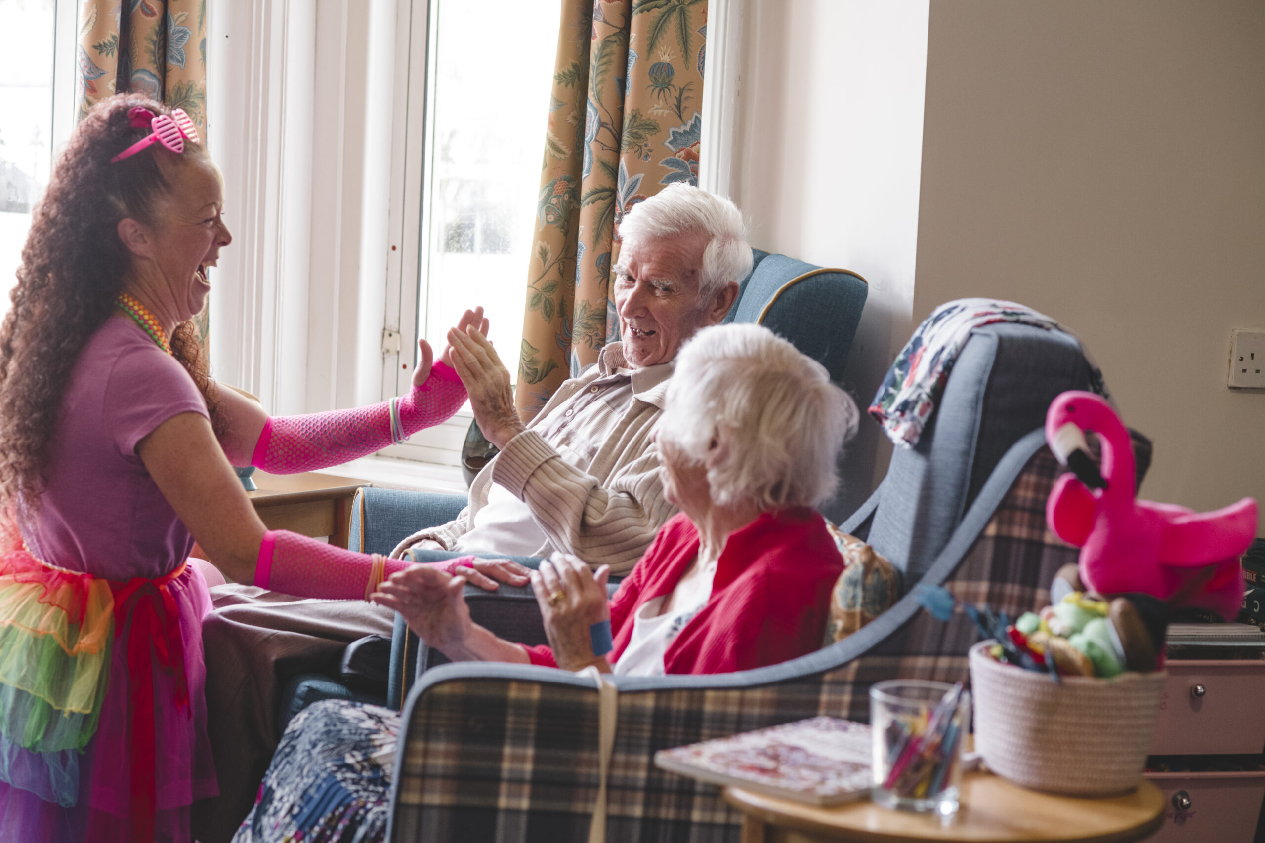 Activities coordinator Kerrie Haughey with residents in the lounge at Parkwood House.