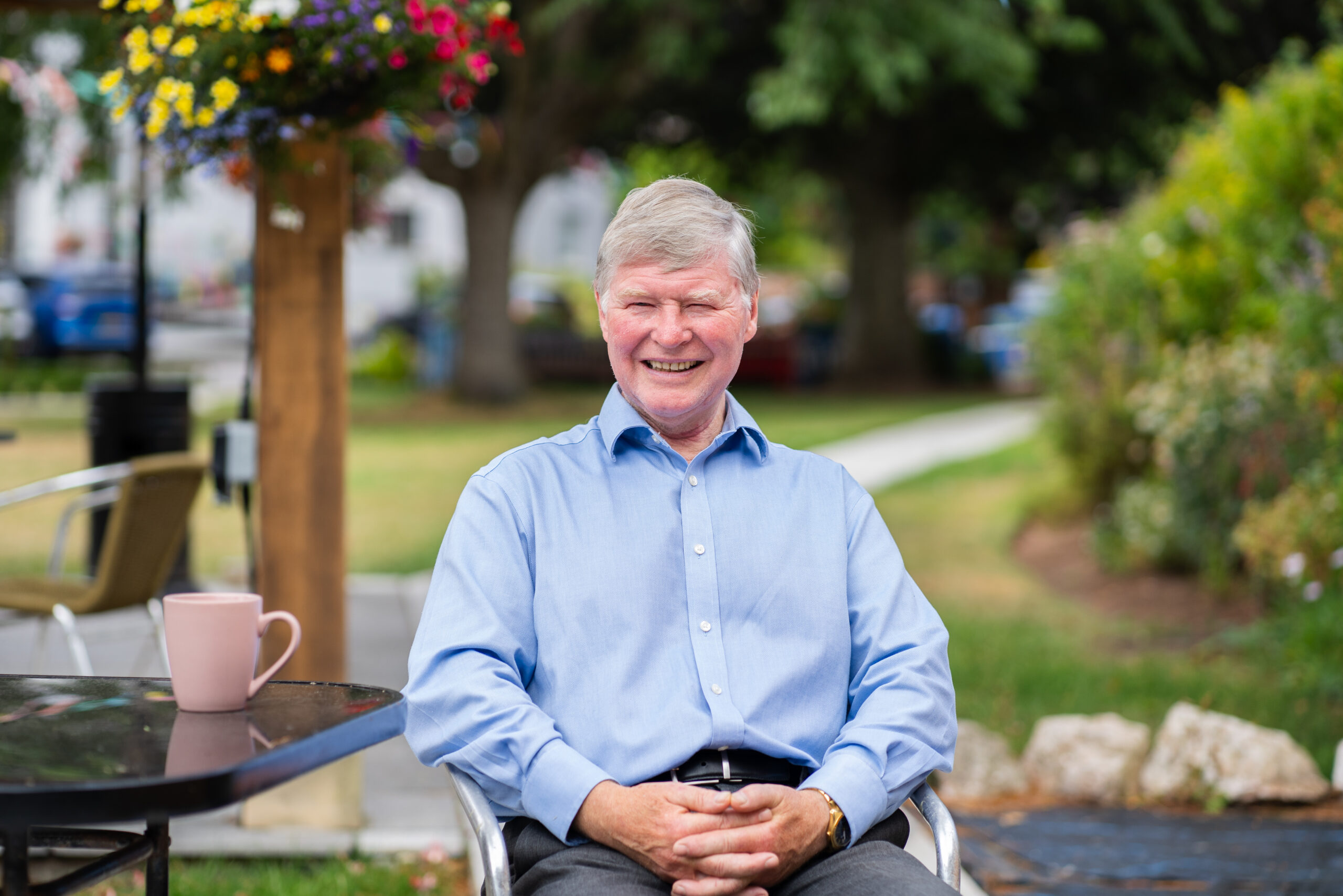 Managing director Geoffrey Cox sitting outside in the gardens at Sefton Hall care home in Dawlish.