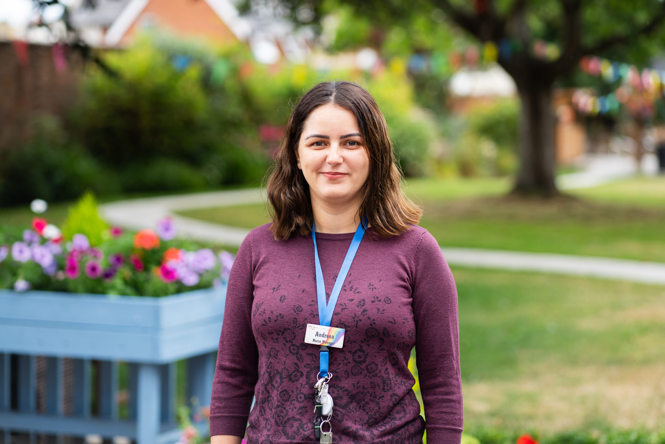 Andreea Vieru, a nurse manager at Sefton Hall care home in Dawlish standing in the garden