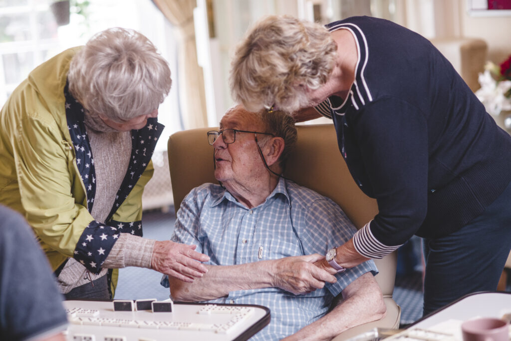 A Sefton Hall resident enjoys time with family and friends in the lounge
