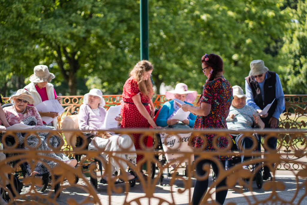 Parkwood House residents enjoy some singing and games on the bandstand at Devonport Park in Plymouth.