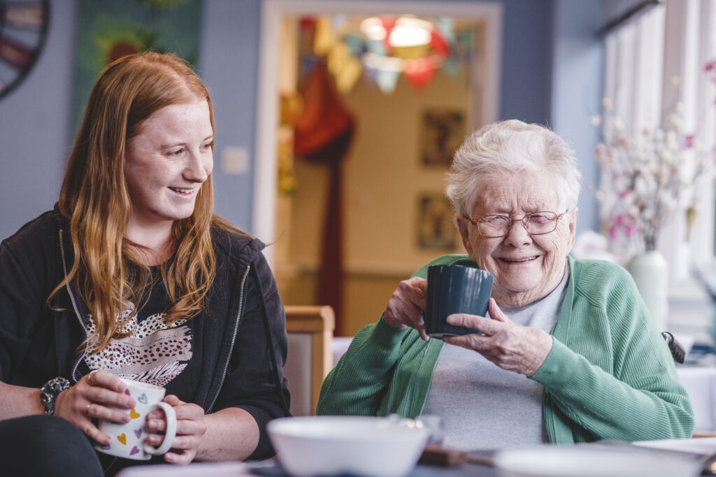 Time time for two at The Old Rectory. A resident and a member of the care team enjoy a chat with a cup of tea.  