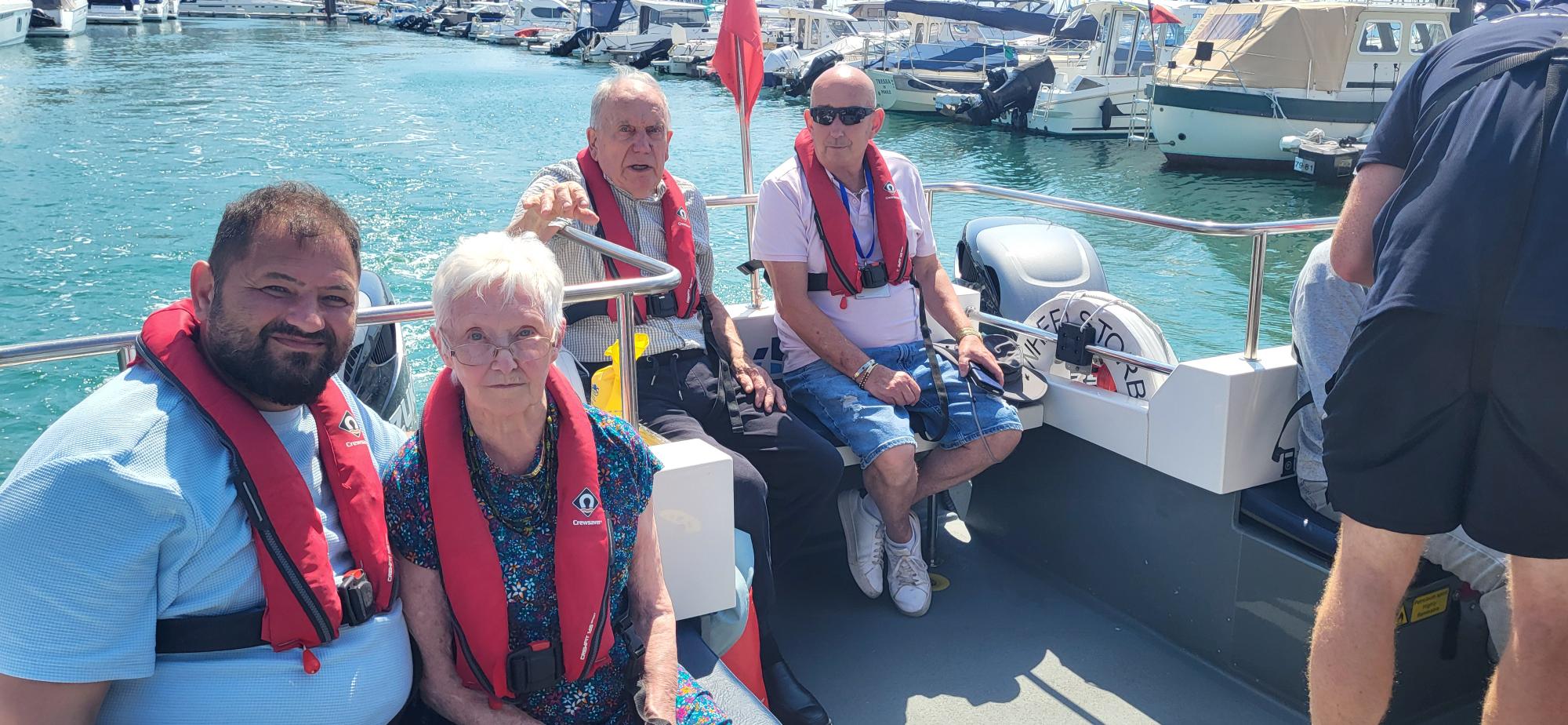 Residents-and-team-members-from-the-Old-Rectory-nursing-home-wear life jackets on a boat trip
