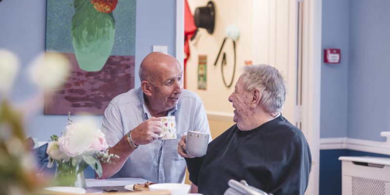 Carer Andy Cowling and resident Ron Letheren enjoy a cup of tea and a chat in the The Old Rectory dining room