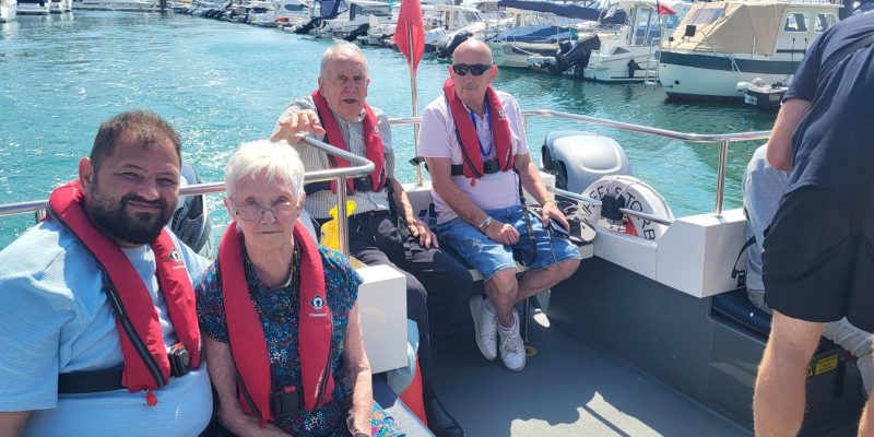 Residents-and-team-members-from-the-Old-Rectory-nursing-home-wear life jackets on a boat trip