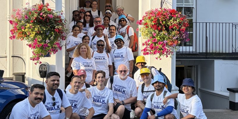 Southern Healthcare team members gather outside the entrance to Sefton Hall nursing home after their 15 mile walk